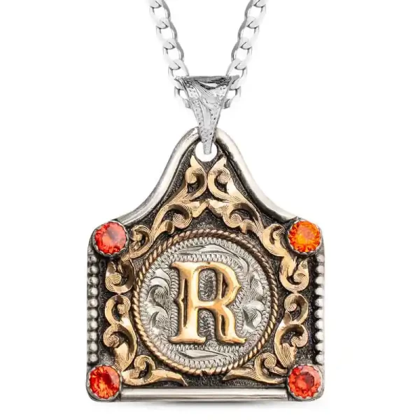 Celebrate your school pride with the Initial Cow Tag Graduation Necklace! This elegant piece features a German Silver base with a classic inner rope border, Jewelers Bronze overlays, and a beaded edge. Personalize it with your school colors and initials f